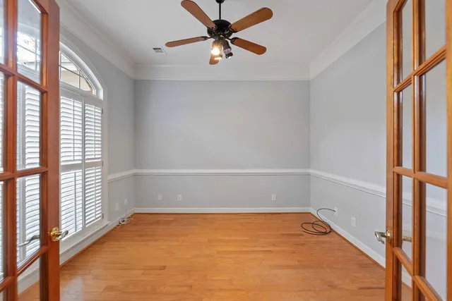 a view of a room with wooden floor and a window