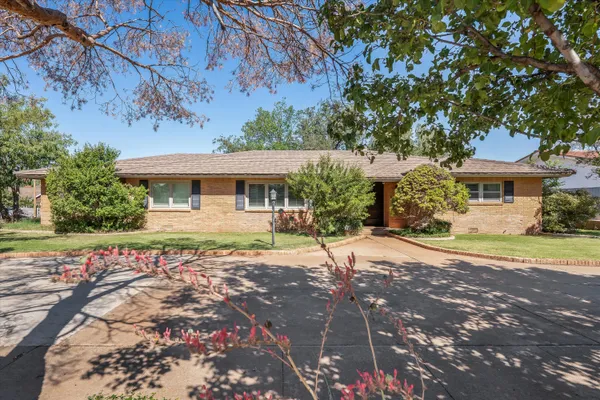 a front view of a house with a yard and a garage