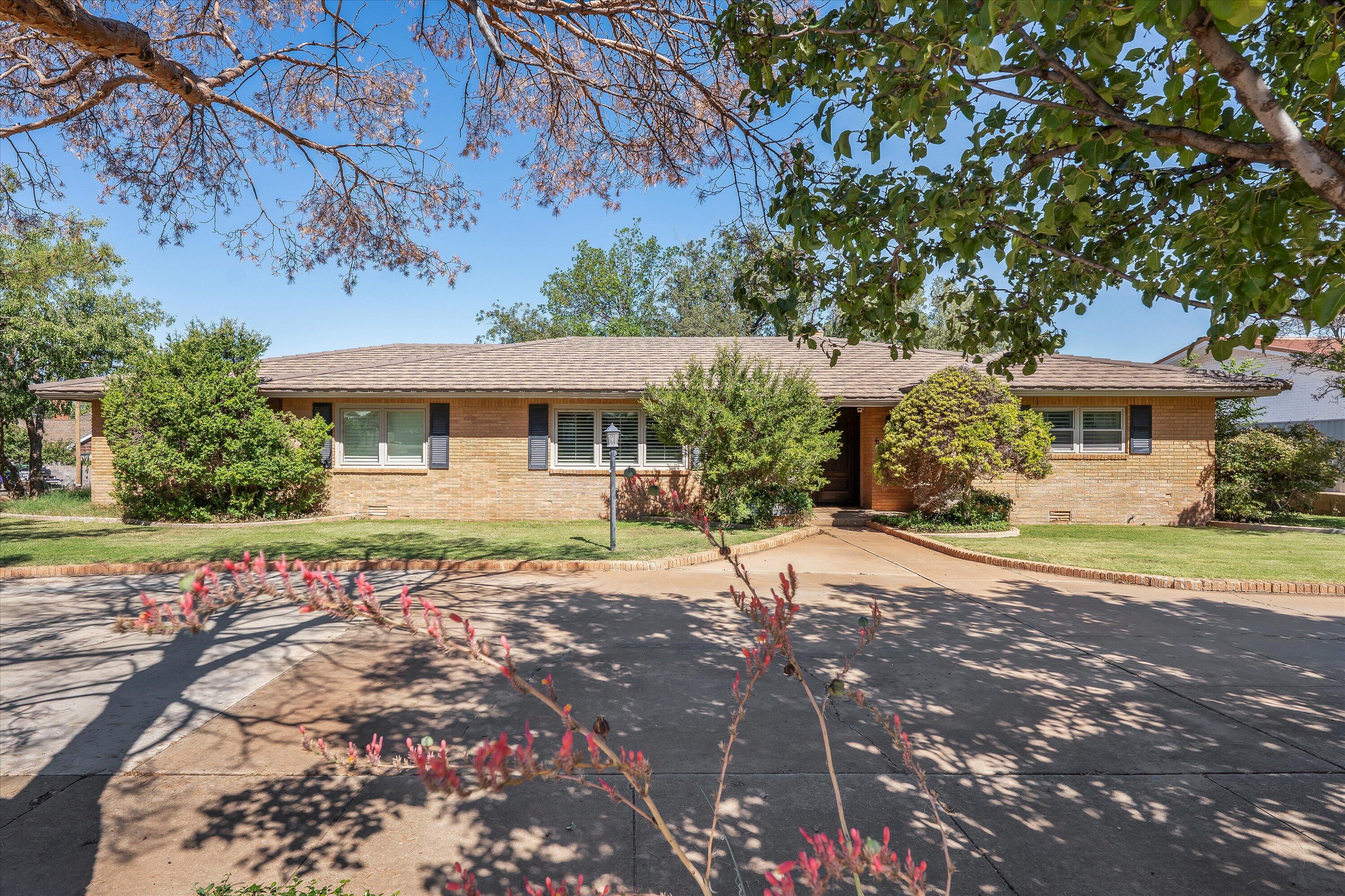a front view of a house with a yard and a garage
