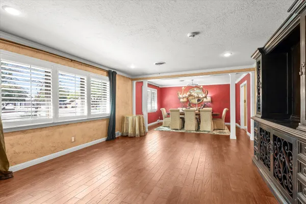 a living room with furniture flat screen tv and wooden floor