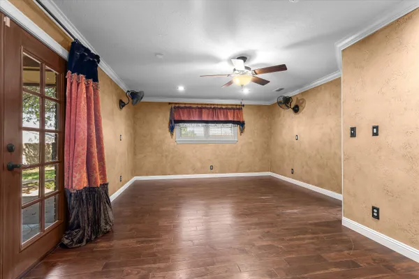 wooden floor in an empty room with a window
