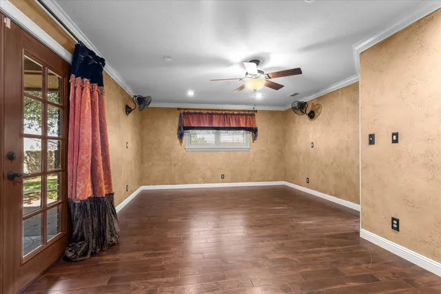 wooden floor in an empty room with a window