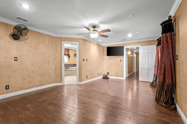 a view of an empty room with wooden floor