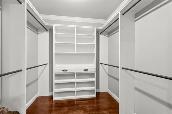 a view of walk in closet with empty racks