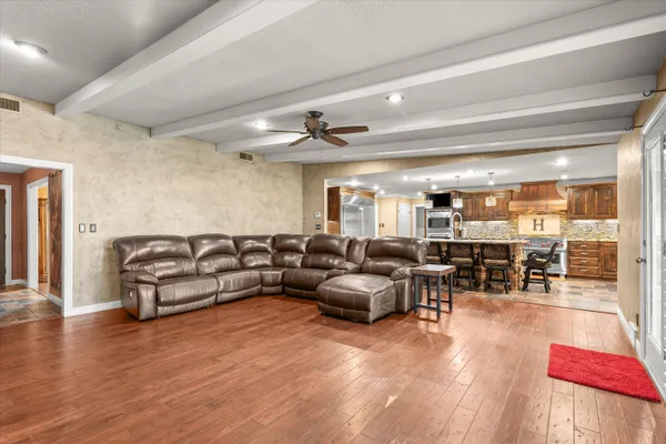 a living room with furniture and wooden floor