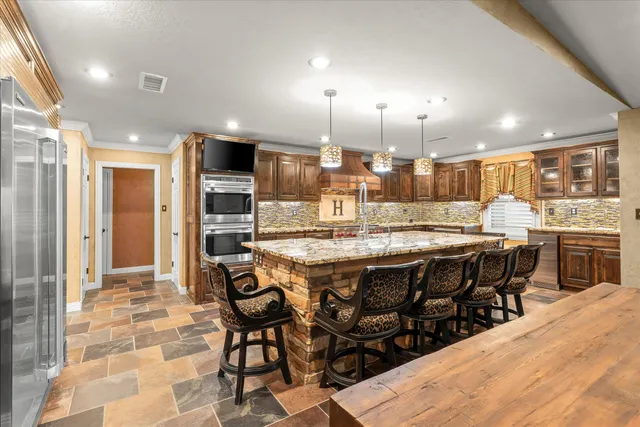 a large kitchen with a table and chairs