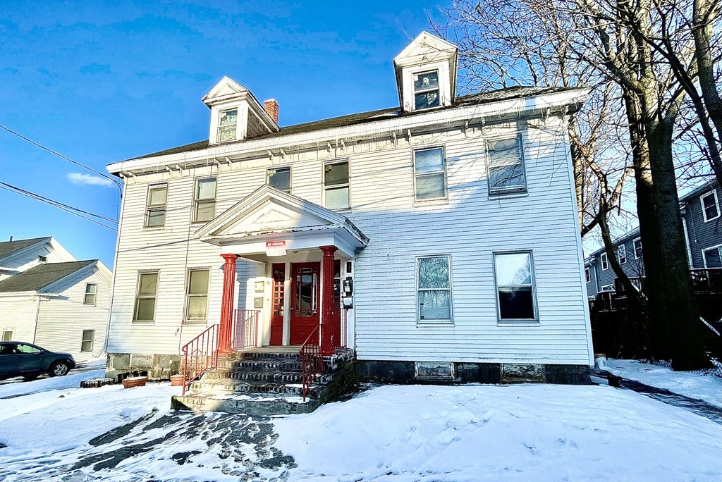 68 Smith Street Lowell, MA 01851 - Photo 1 of 24 a front view of a house with large windows
