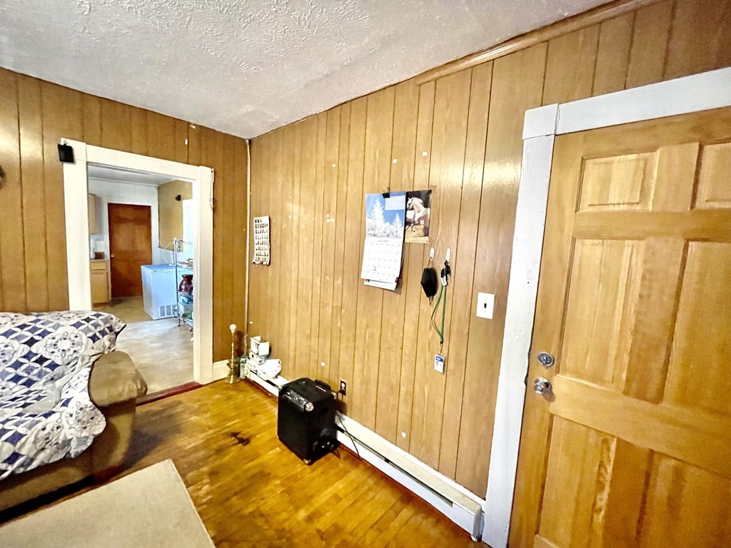 68 Smith Street Lowell, MA 01851 - Photo 11 of 24 a bedroom with a bed and a dresser