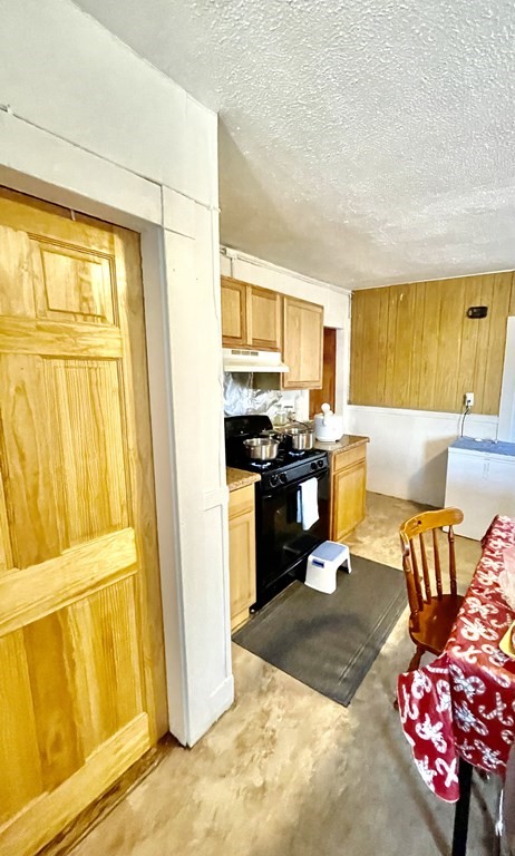 68 Smith Street Lowell, MA 01851 - Photo 12 of 24 a kitchen with stainless steel appliances granite countertop a refrigerator and a stove top oven