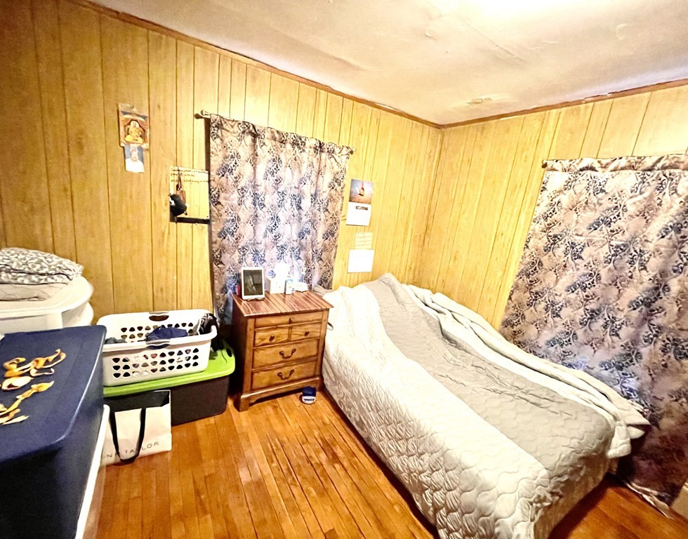 68 Smith Street Lowell, MA 01851 - Photo 13 of 24 a spacious bedroom with a bed and a window
