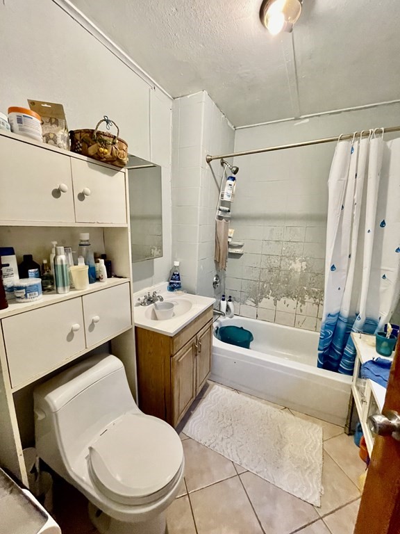 68 Smith Street Lowell, MA 01851 - Photo 14 of 24 a bathroom with a sink a toilet and shower