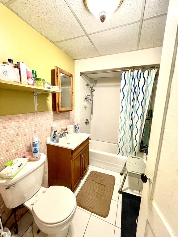 68 Smith Street Lowell, MA 01851 - Photo 17 of 24 a bathroom with a sink a toilet and bathtub