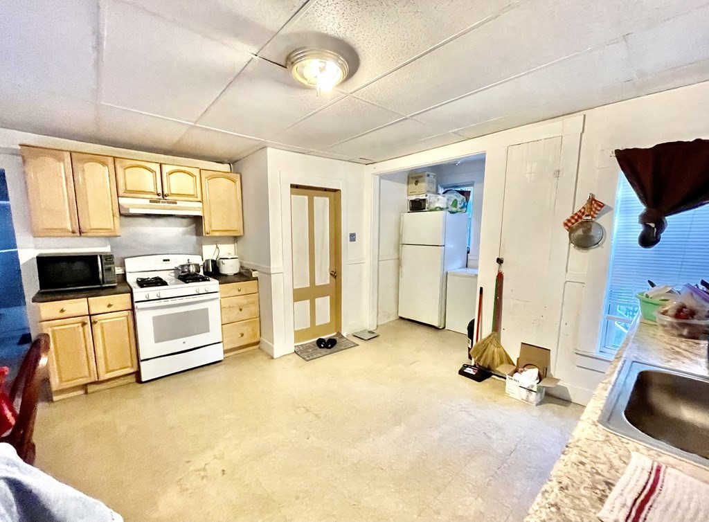 68 Smith Street Lowell, MA 01851 - Photo 7 of 24 a view of a kitchen with appliances and cabinets