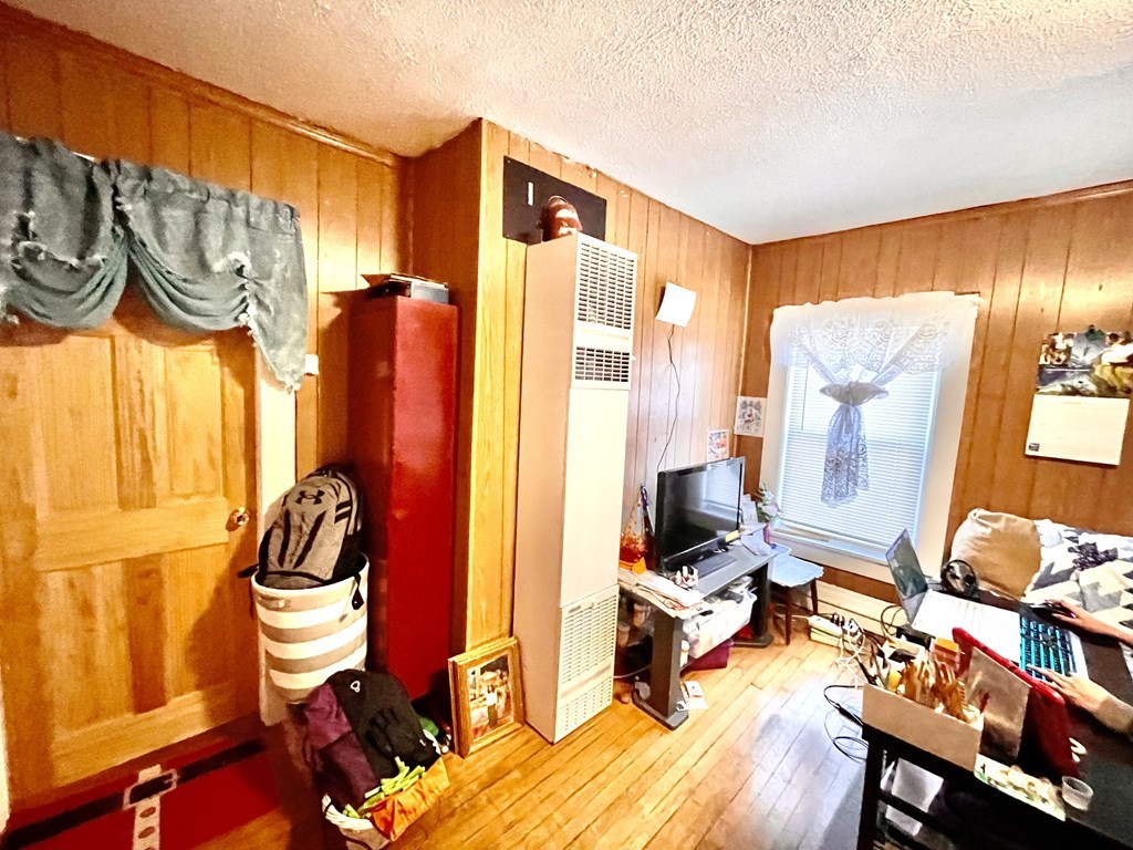 68 Smith Street Lowell, MA 01851 - Photo 10 of 24 a bedroom with a bed and a window
