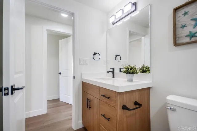 a bathroom with a sink vanity and a mirror