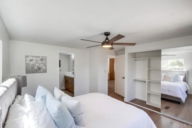 a bedroom with a large bed and a chandelier