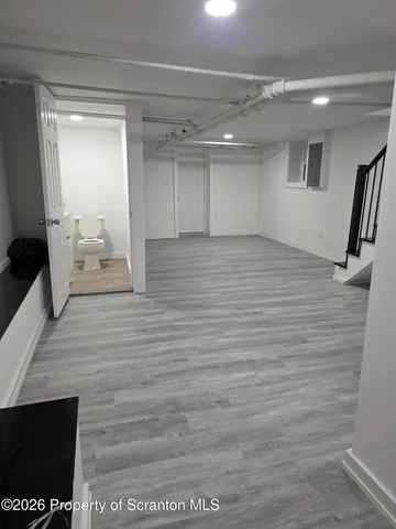 a room with a wooden floor and a large window