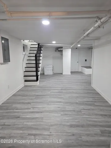 a view of a hallway with stairs and a window