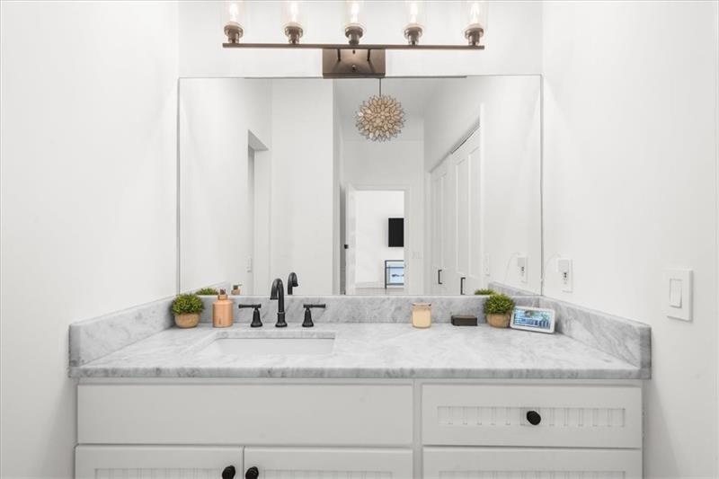 3475 Oak Valley Road Northeast, Unit 410 Atlanta, GA 30326 - Photo 12 of 36 a bathroom with a sink and a mirror