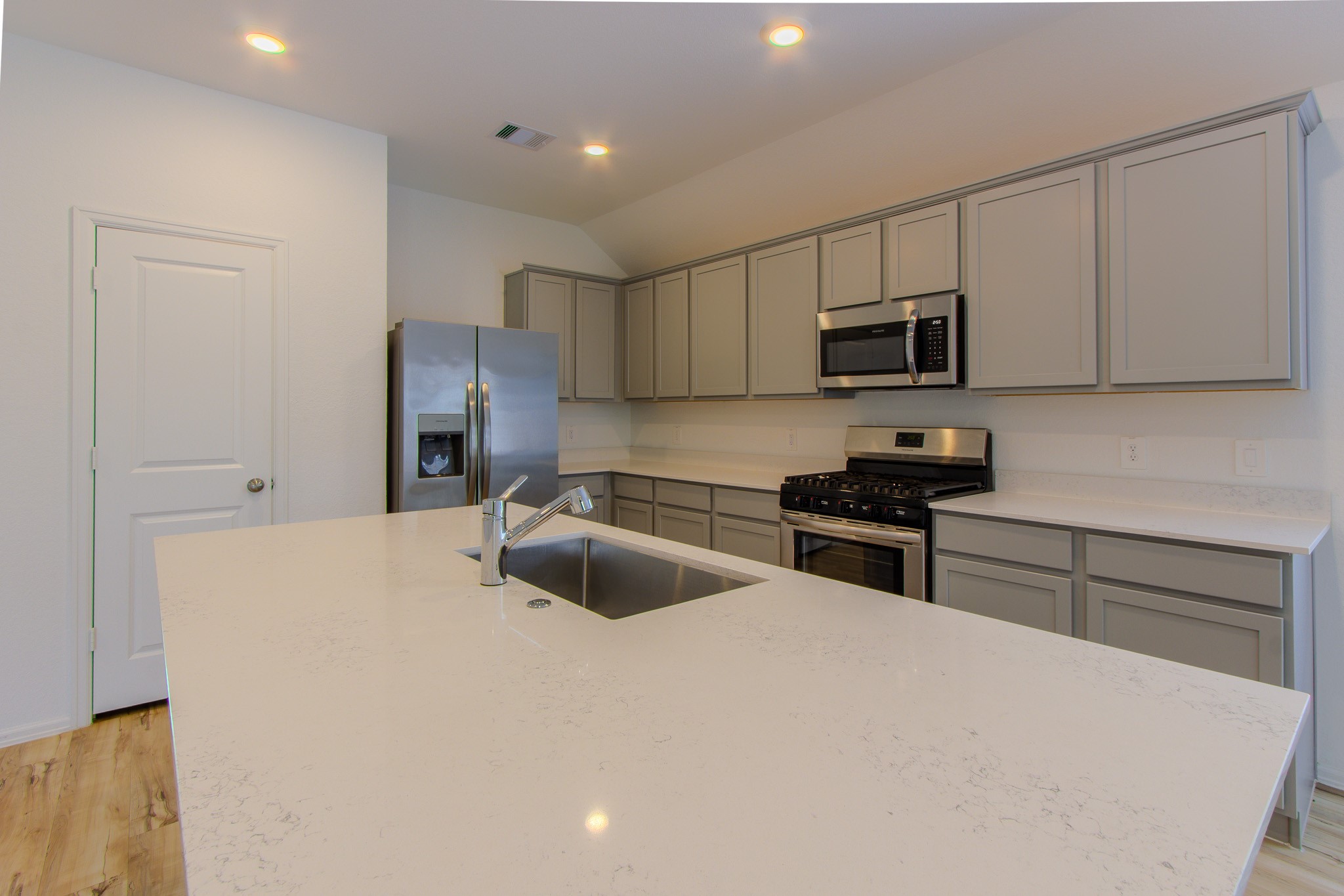 3113 Catalonion Court Conroe, TX 77301 - Photo 13 of 45 a kitchen with stainless steel appliances a refrigerator sink and microwave