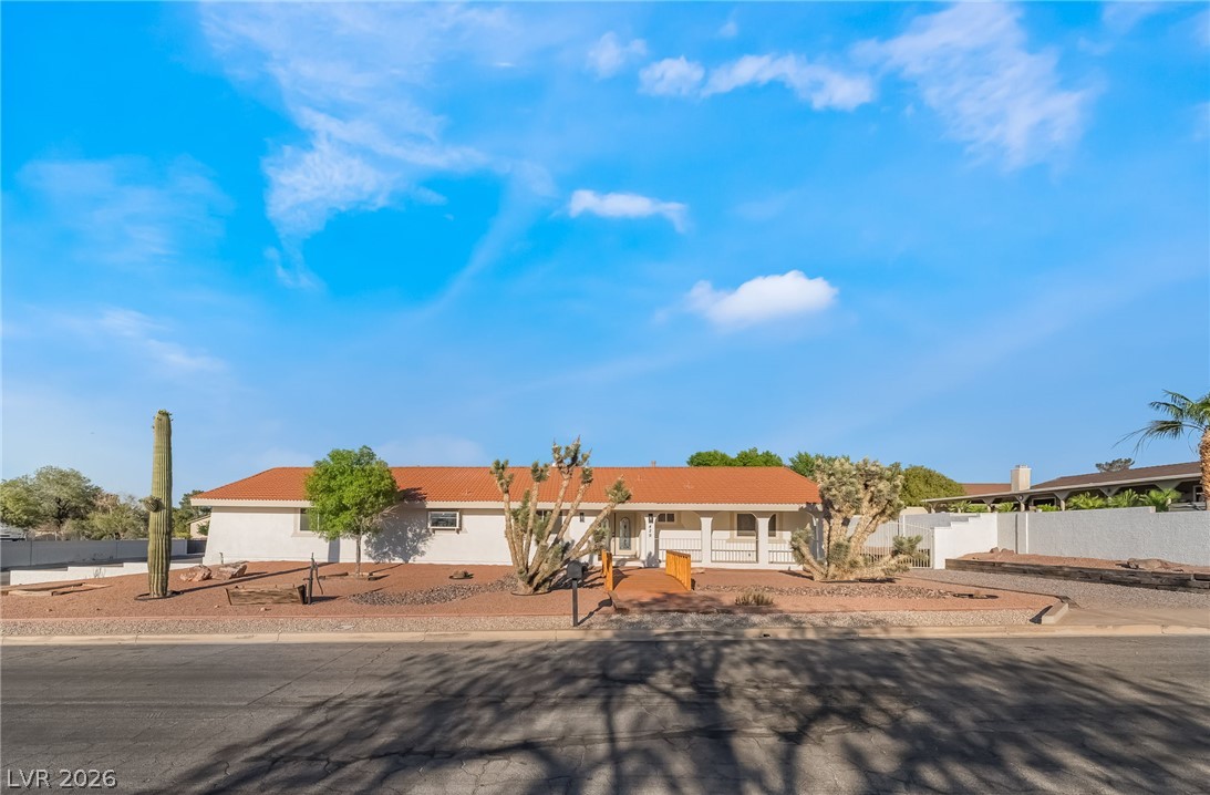 429 Crestway Road Henderson, NV 89015 - Photo 1 of 59 An inviting single-story facade features desert landscaping and a Spanish tile roof under wide skies.
