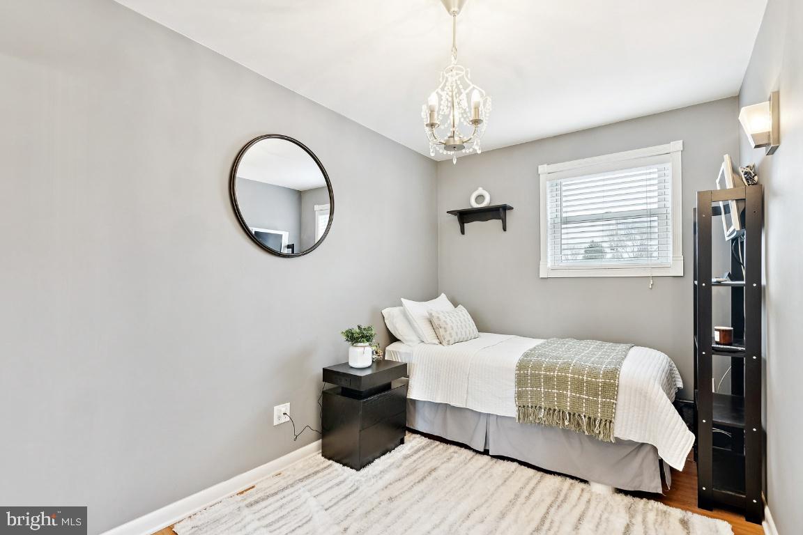 13 Belmont Road Bellmawr, NJ 08031 - Photo 13 of 32 a bedroom with a bed and a chandelier