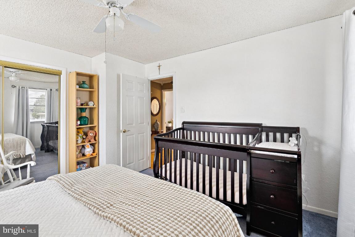 13 Belmont Road Bellmawr, NJ 08031 - Photo 14 of 32 a bedroom with bed and wooden floor