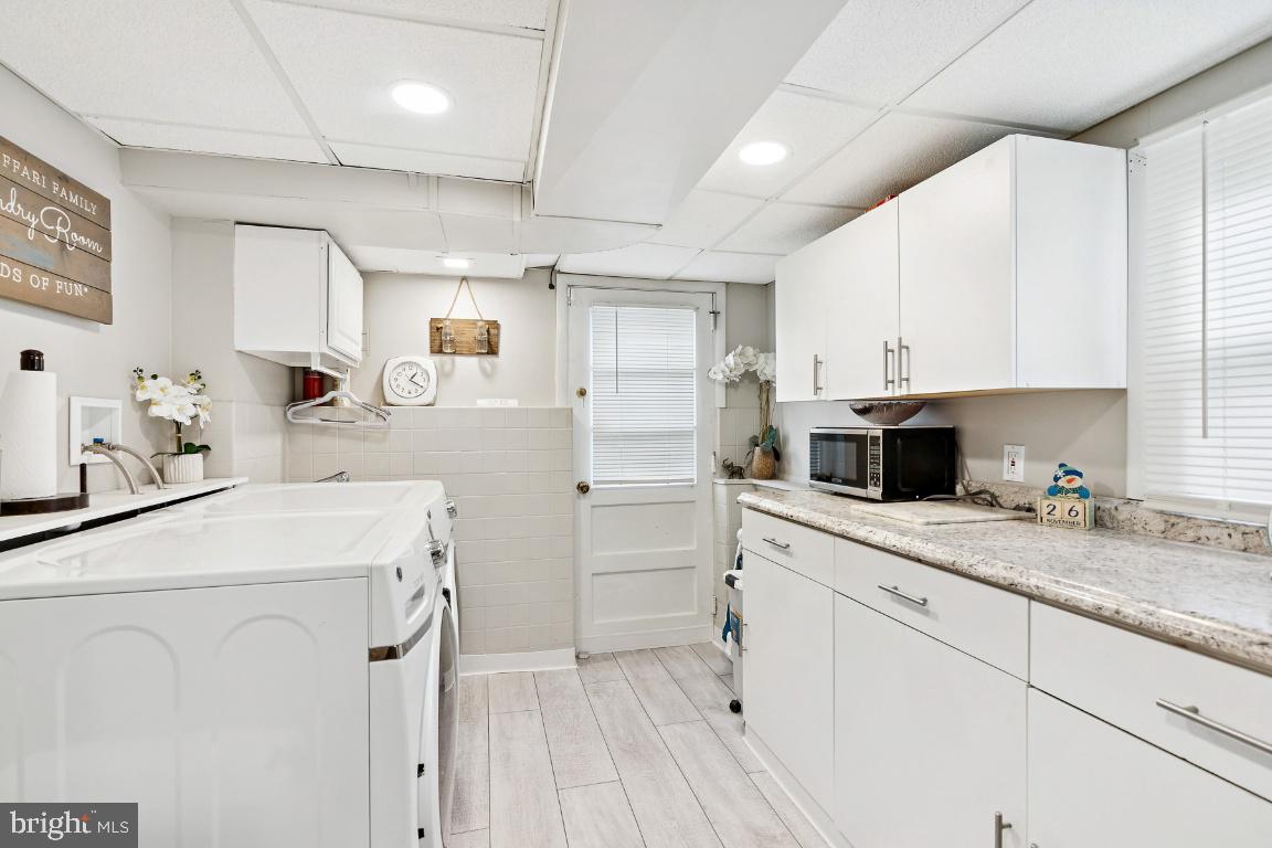 13 Belmont Road Bellmawr, NJ 08031 - Photo 17 of 32 a kitchen with a sink dishwasher and white stove with cabinets