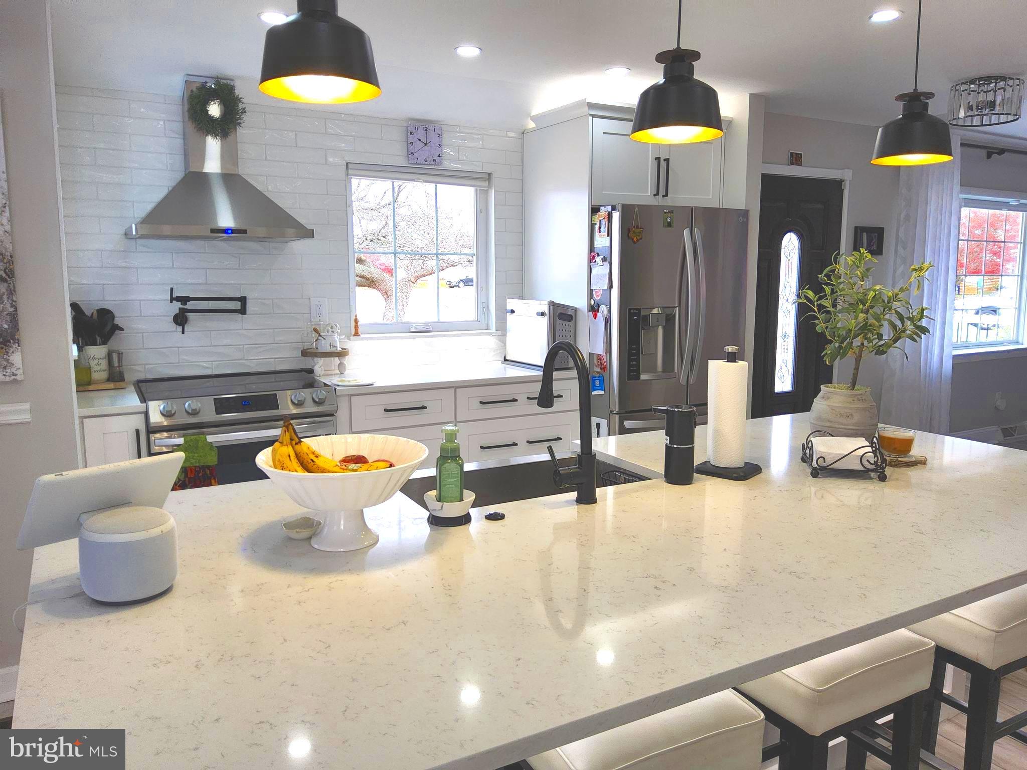 13 Belmont Road Bellmawr, NJ 08031 - Photo 23 of 32 a kitchen with a sink a counter and chairs