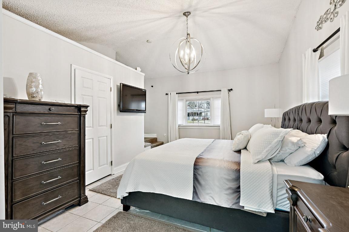 13 Belmont Road Bellmawr, NJ 08031 - Photo 8 of 32 a bedroom with a bed and a tv