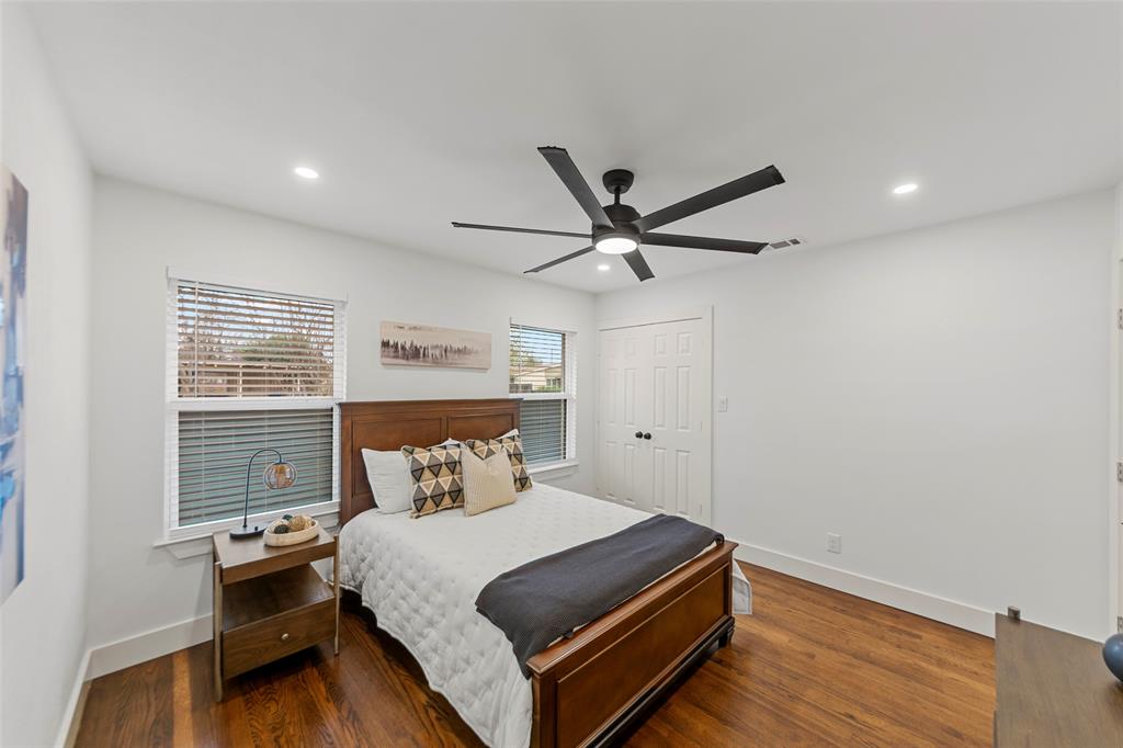 2945 Healey Drive Dallas, TX 75228 - Photo 20 of 38 a bedroom with a bed and a ceiling fan