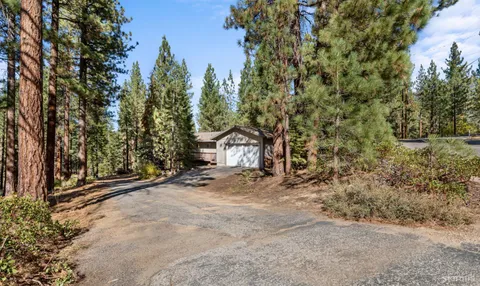 a view of wooden fence and trees around