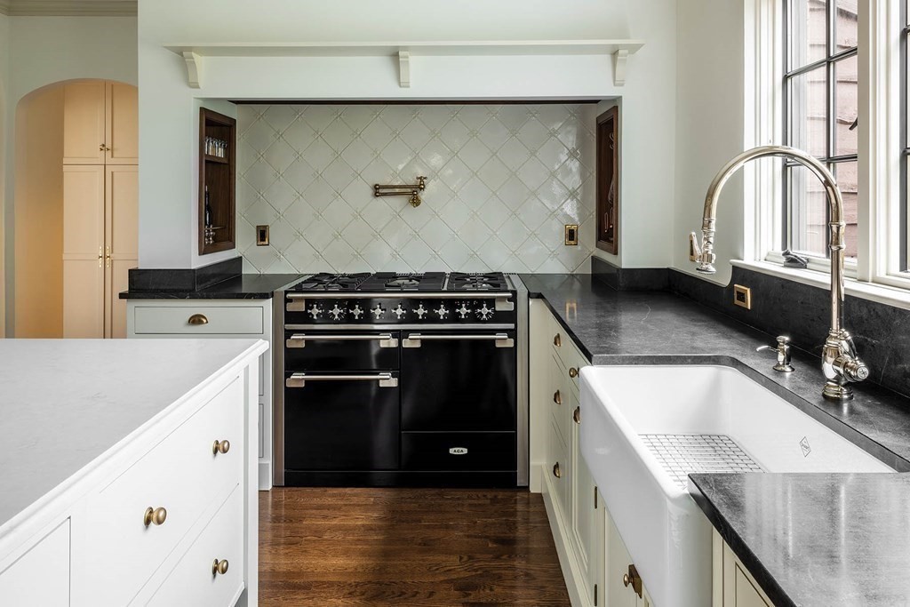 92 Gordon Road Newton, MA 02468 - Photo 5 of 16 a kitchen with granite countertop a stove a sink and a microwave