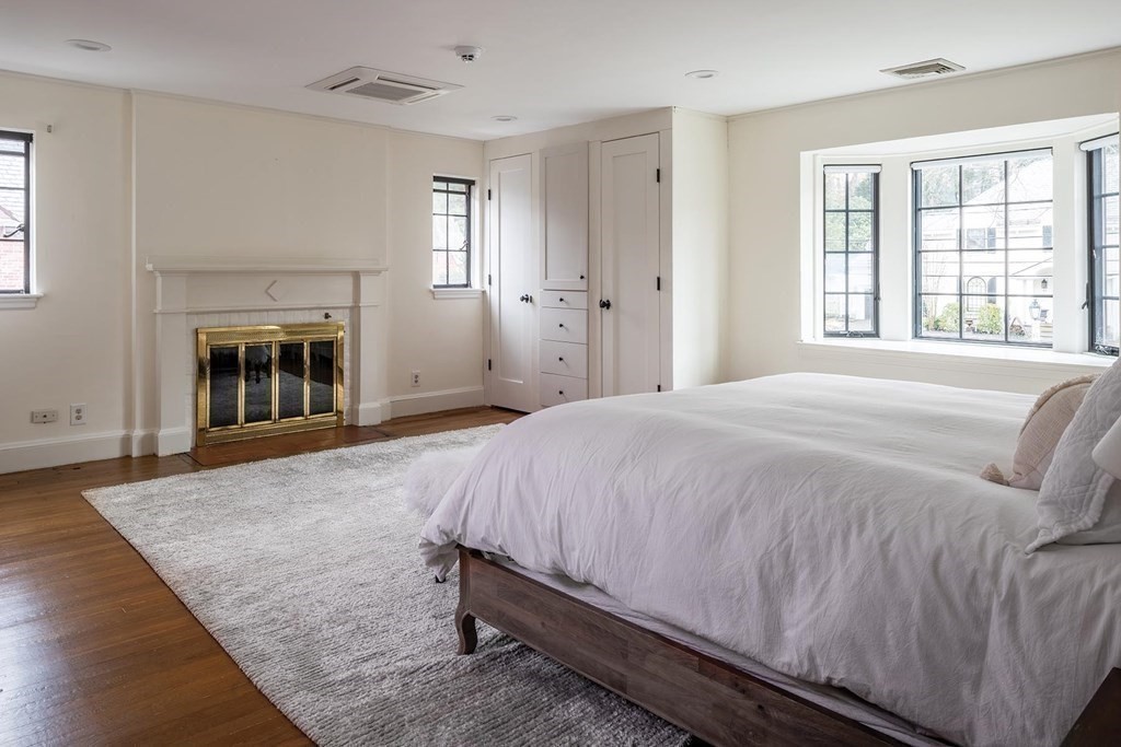 92 Gordon Road Newton, MA 02468 - Photo 8 of 16 a spacious bedroom with a bed and a fireplace