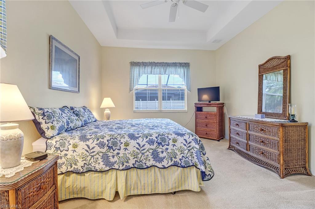 76 Glen Eagle Circle Naples, FL 34104 - Photo 13 of 23 a bedroom with a bed and wooden furniture