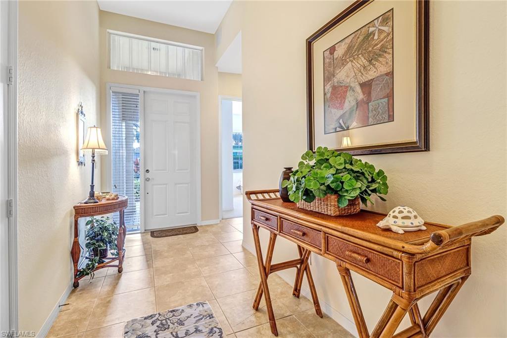 76 Glen Eagle Circle Naples, FL 34104 - Photo 2 of 23 a dining room with furniture and wooden floor