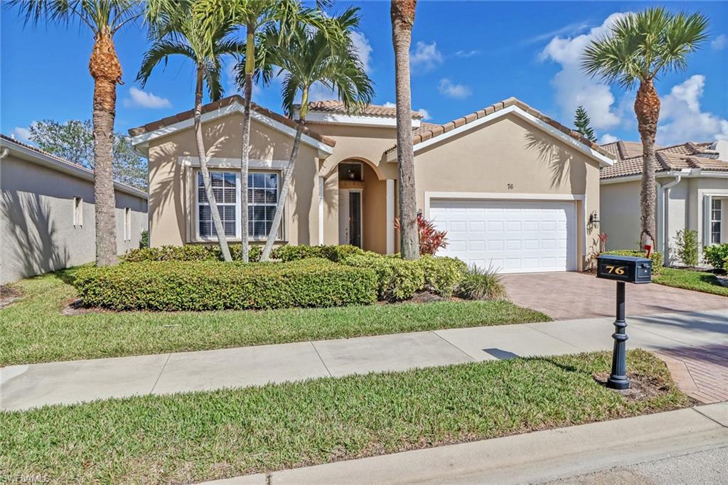 76 Glen Eagle Circle Naples, FL 34104 - Photo 21 of 23 a front view of a house with a garden