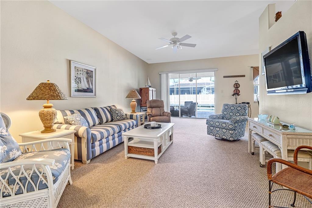 76 Glen Eagle Circle Naples, FL 34104 - Photo 5 of 23 a living room with furniture and flat screen tv