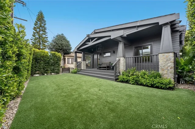 a large kitchen with stainless steel appliances granite countertop a sink a stove and a refrigerator