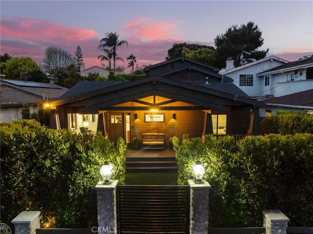 a front view of a house with a yard balcony