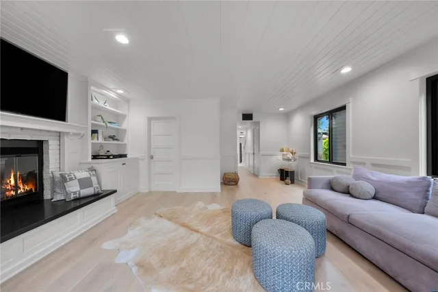 a spacious bedroom with a bed a fireplace and a chandelier