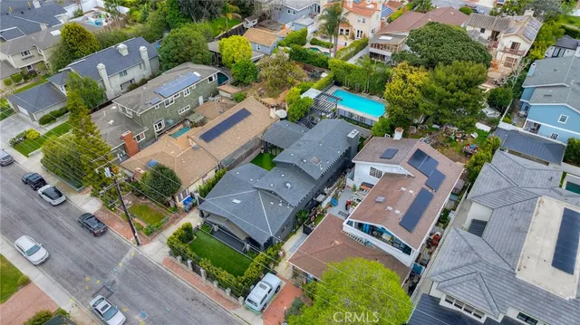 a view of a patio with couches and table and chairs with wooden fence
