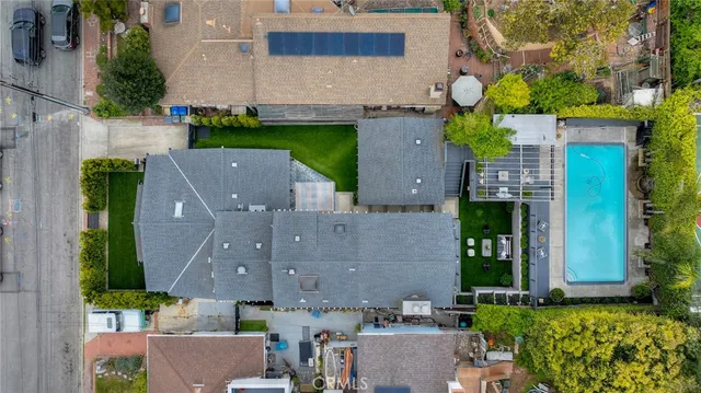 a view of a patio with table and chairs potted plants and palm trees