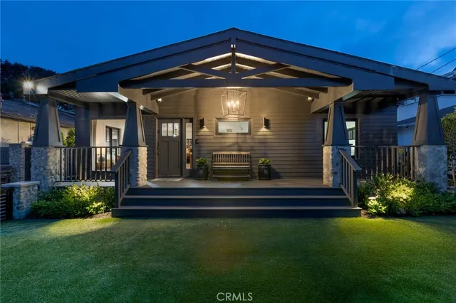 a front view of a house with a garden