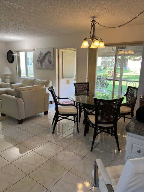 311 Pine Ridge Circle, Unit B1 Greenacres, FL 33463 - Photo 2 of 7 a living room with furniture and a large window