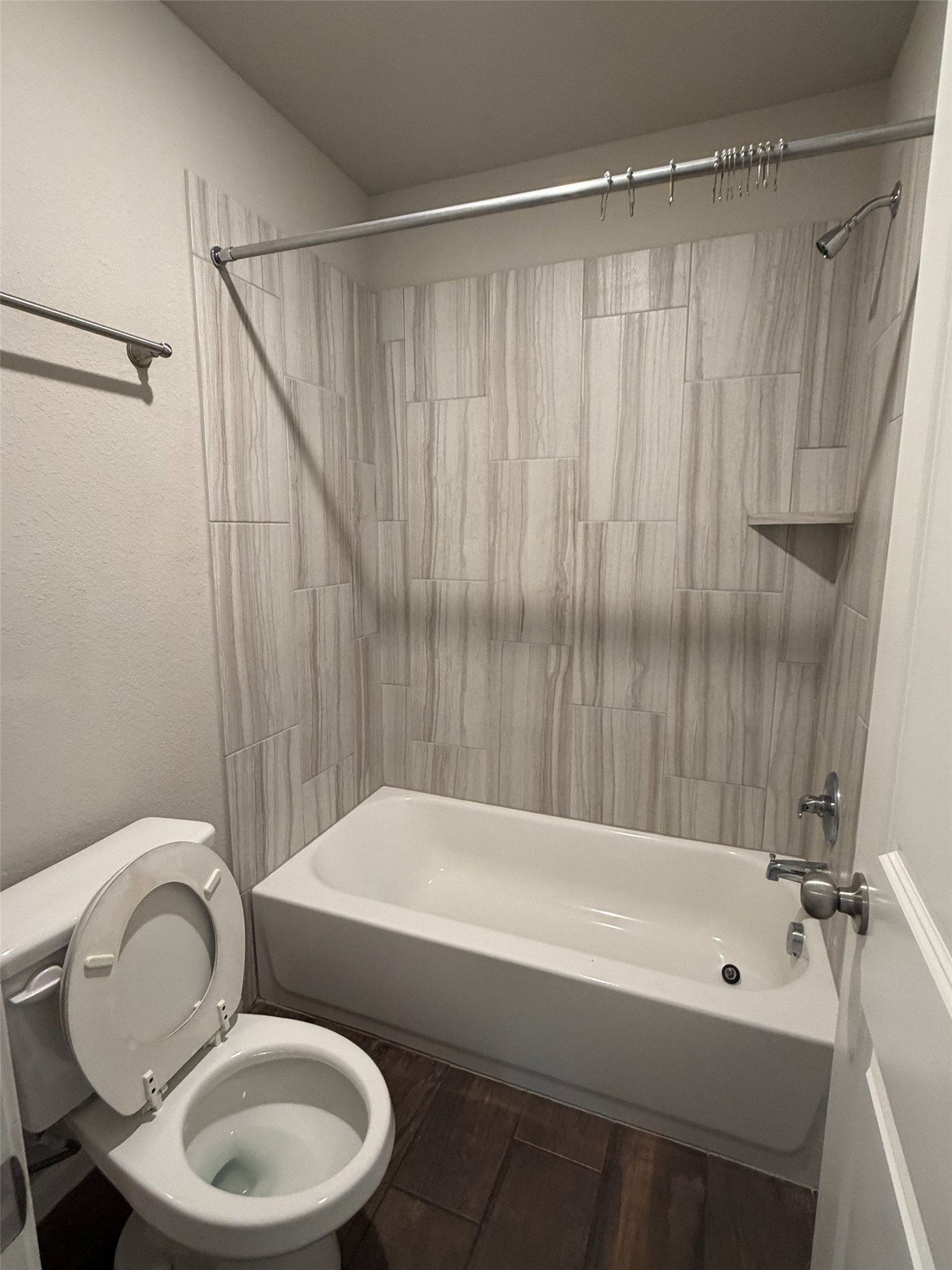 248 Falling Star Lane Georgetown, TX 78628 - Photo 9 of 16 A well-appointed bathroom features a bathtub and shower combination with stylish tiled walls.