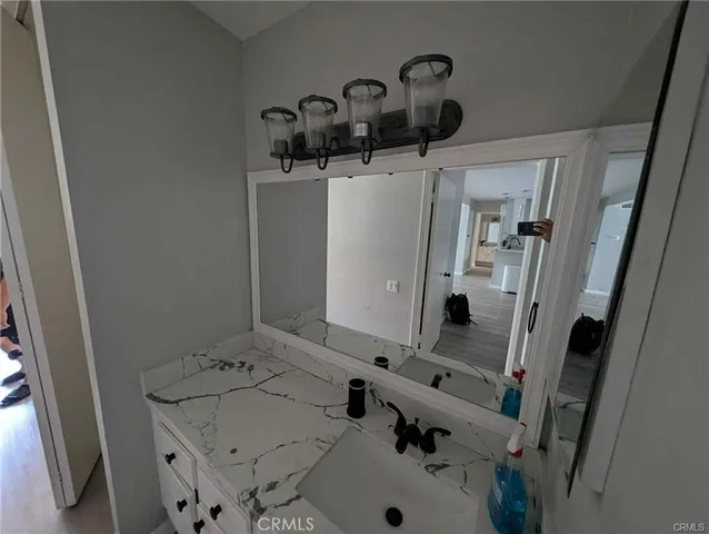 a bathroom with a sink and mirror