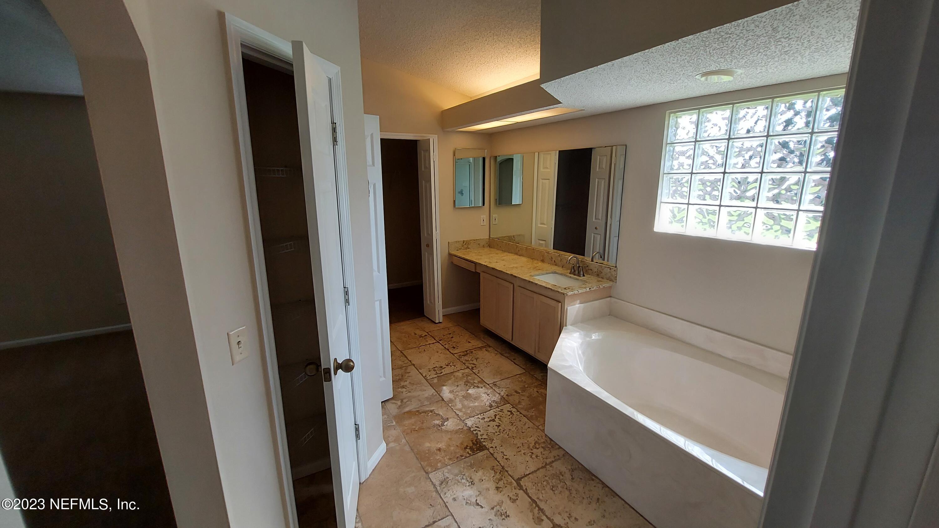 1763 Pickwick Place Orange Park, FL 32003 - Photo 14 of 24 a view of bathroom with bathtub and shower