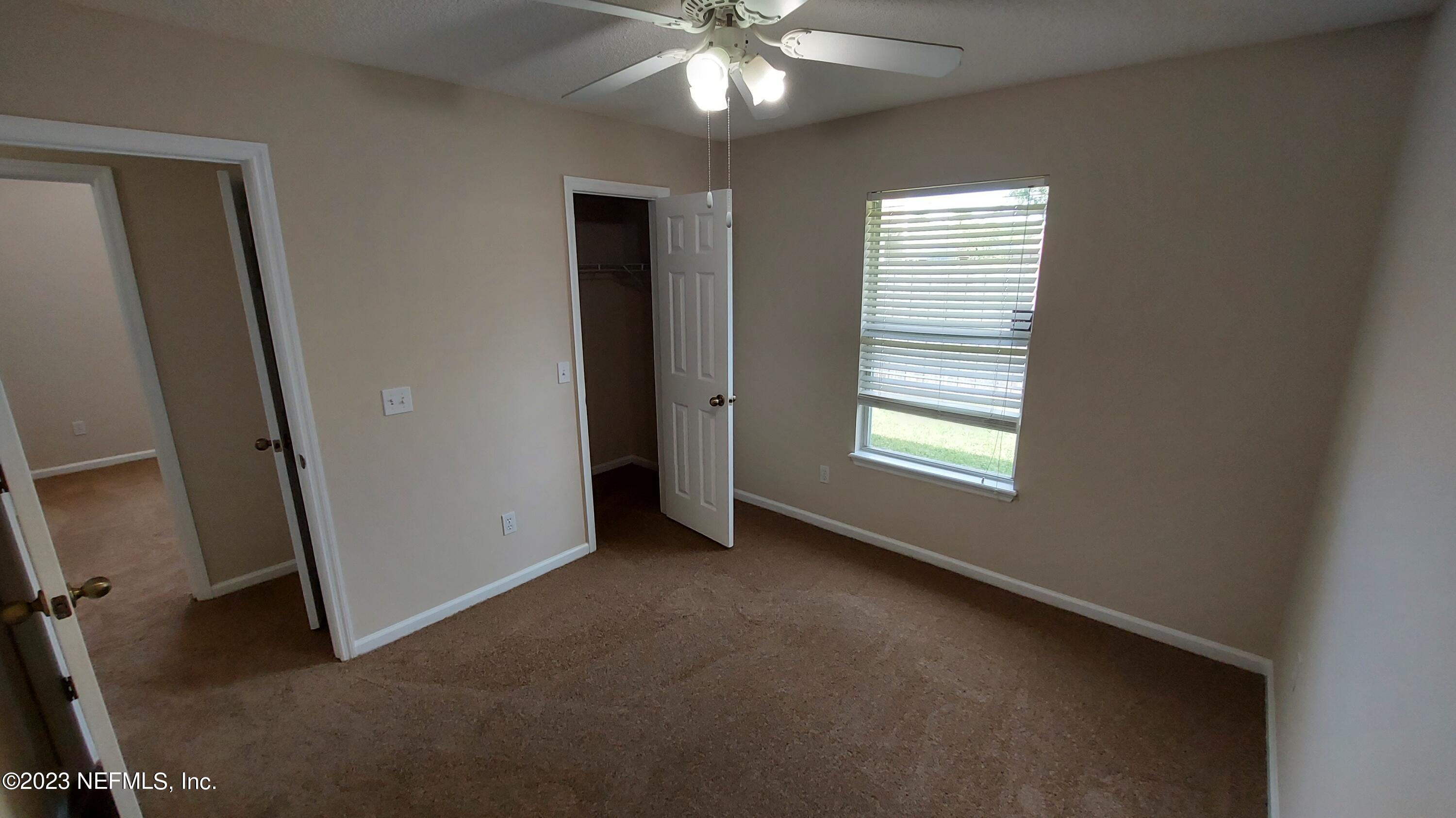 1763 Pickwick Place Orange Park, FL 32003 - Photo 16 of 24 an empty room with windows and fan