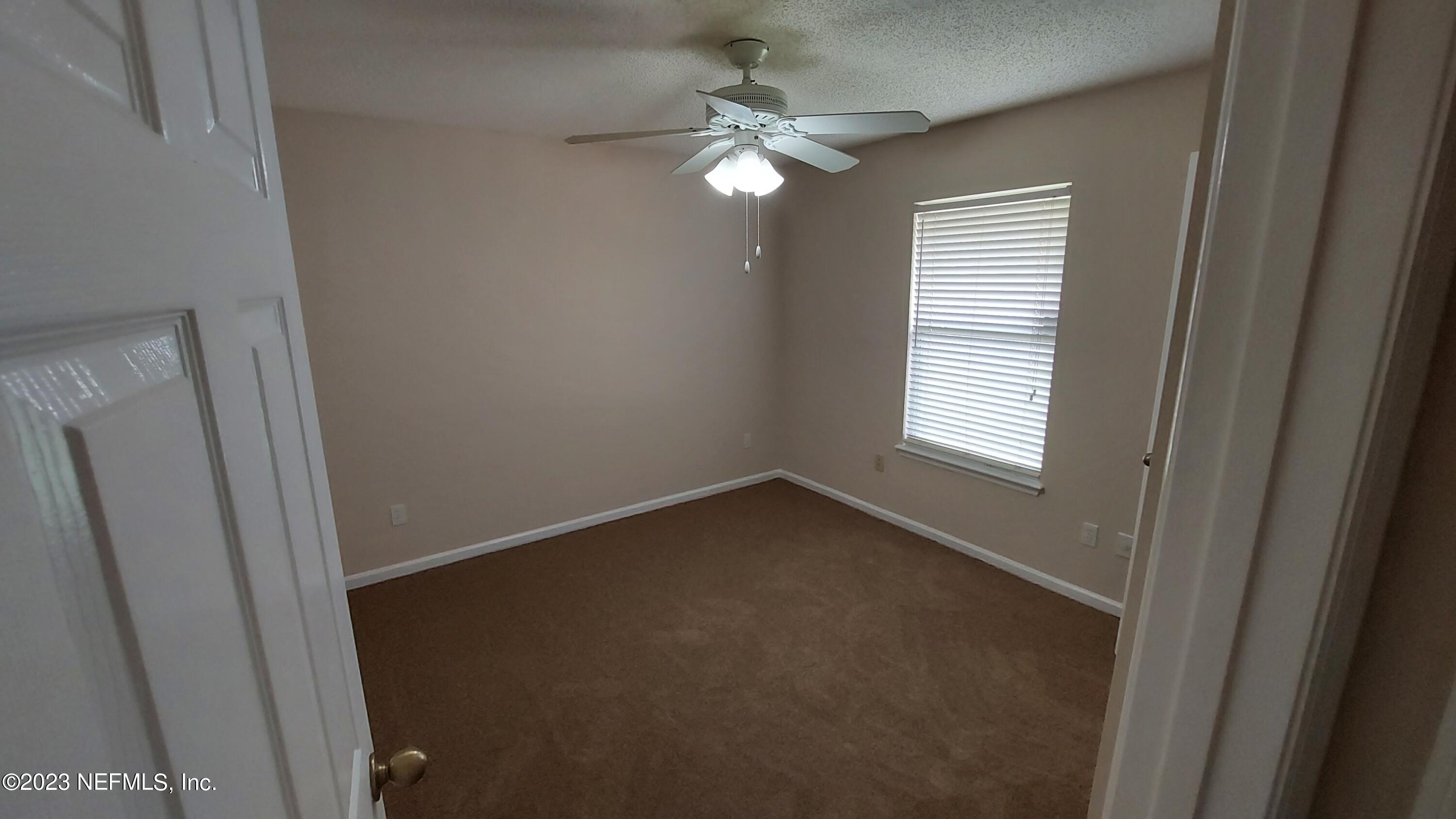 1763 Pickwick Place Orange Park, FL 32003 - Photo 17 of 24 a view of an empty room with a window
